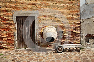 Concrete mixer at the brick wall