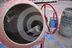 Red concrete mixer with cement inside