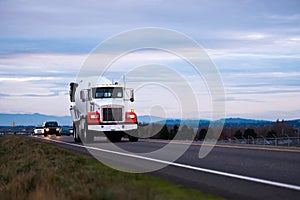 Concrete mixer classic big rig semi truck on evening road