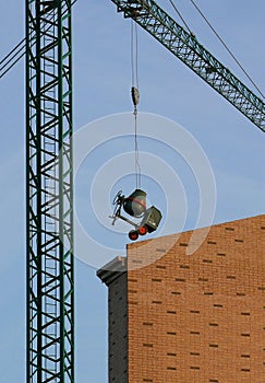 Concrete-mixer suspended from a crane