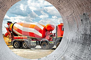 Concrete mixer truck in front of a concrete batching plant, cement factory. Loading concrete mixer truck. Close-up. Delivery of