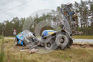 Concrete mixer truck involved in a car accident and driven off the road