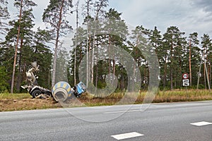 Concrete mixer truck involved in a car accident and driven off the road