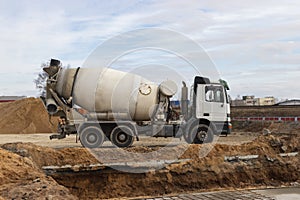 Concrete mixer truck loads concrete at the factory. Transportation of concrete to the construction site. Construction equipment fo