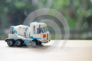 Concrete mixer truck plastic toy on wood table