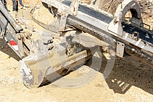 Concrete mixer truck pouring fresh wet concrete into excavators bucket at construction site