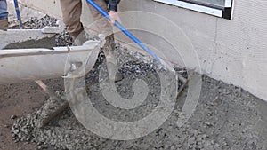 Concrete mixing truck pouring fresh pavement for new house