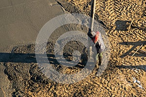 Concrete mixture formwork, worker pouring on a building construction site