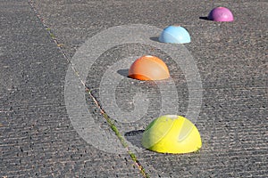 Concrete multi-colored hemispheres restricting the entry of cars