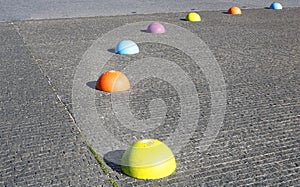 Concrete multi-colored hemispheres restricting the entry of cars