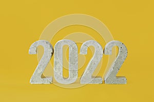 Concrete numbers 2022 on a yellow background.