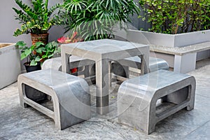 Concrete outdoor furniture set in small garden
