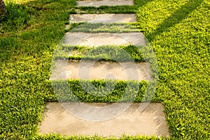 concrete path lawn pedal rectangular shape in regular grid routed directly through beautiful lawn suns and shadows stone
