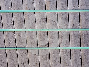 Concrete paving slabs bundled and secured with plastic strap.