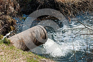 Concrete pipe transporting the poluted river