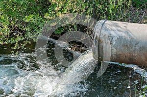 Concrete pipe transporting the poluted river