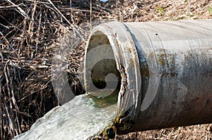 Concrete pipe transporting the poluted river photo