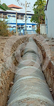 Concrete pipeline construction site along the road