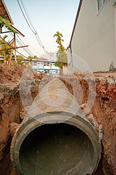 Concrete pipeline construction site along the road