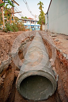 Concrete pipeline construction site along the road