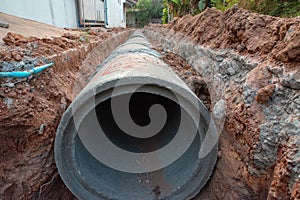 Concrete pipeline construction site along the road