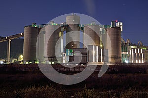 Concrete plant silos by night