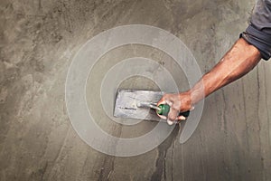 Concrete plasterers to create industrial workers background walls with plastering tools