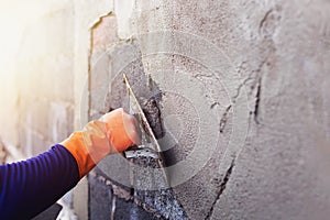 Concrete plasterers to create industrial workers background walls with plastering tools