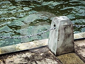 Concrete post on pier with chain