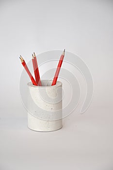 Concrete pot with red pencils