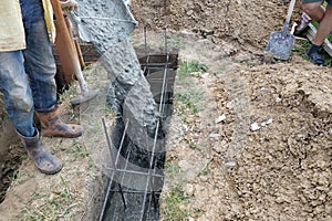 Concrete pouring during commercial concreting of building floors, workers level the concrete