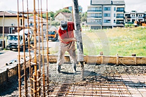 Concrete pouring details - industrial man working on house construction site