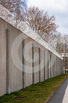Concrete prison wall with surveillance camera