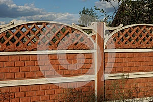 Concrete red  brown fence on a rural street