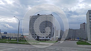 Concrete residential buildings have recently been built in the new city quarter. New roads, lighting poles. Near the houses there