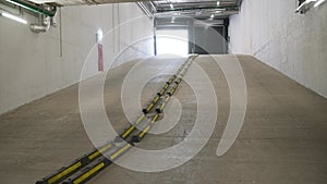 Concrete road leading to the building's parking lot. Departure from the underground parking. Entry and exit from