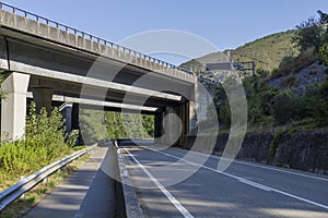 Concrete road viaduct over an empty highway in Spain.