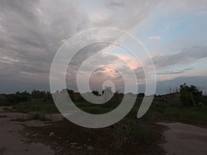Concrete ruins on a cloudy evening. Abandoned farm buildings. Scenery
