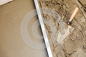 Concrete screed floor align. trowel and rail on wet mortar photo