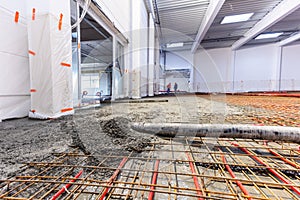 Concrete screed on floor heating in a new warehouse and office building