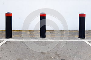 Concrete security bollards, vehicle crash barriers in a parking lot