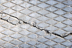 A concrete slab with a crack. The texture of a cracked cement wall