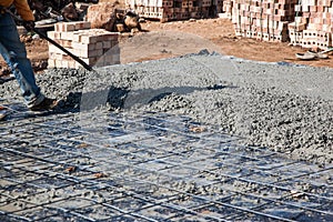 Concrete Slab spreading by Worker to achieve level