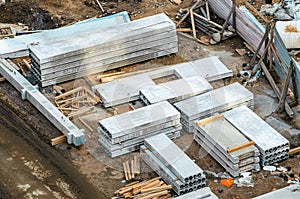 Concrete slabs lie on the construction site of a building from above.