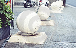 Concrete spheres prohibiting parking barrier on the street in Catania, Sicily, Italy