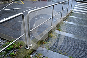 concrete staircase with stainless steel polished tubular railing.
