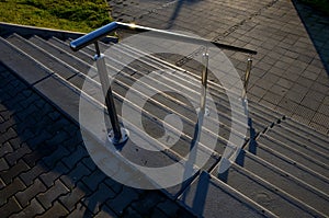 concrete staircase with stainless steel polished tubular railing.