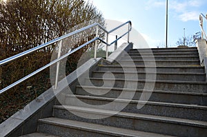 concrete staircase with stainless steel polished tubular railing.
