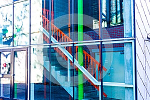 Concrete stairs in the building. Stairs behind the glass. Entrance to the residential building.