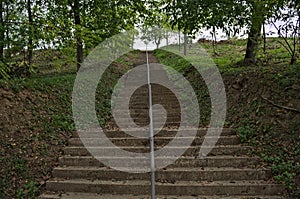 Concrete stairs going up to top of the hill